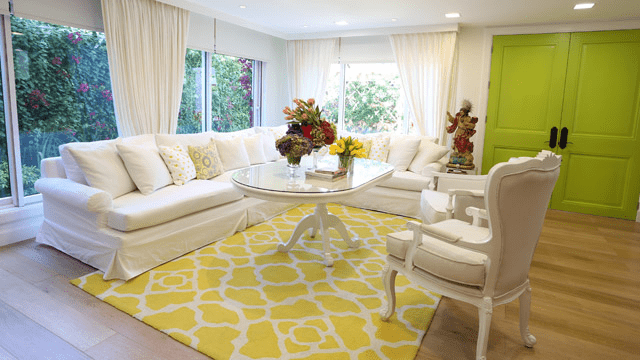 Light-colored luxury home interior with patterns and view of backyard garden.