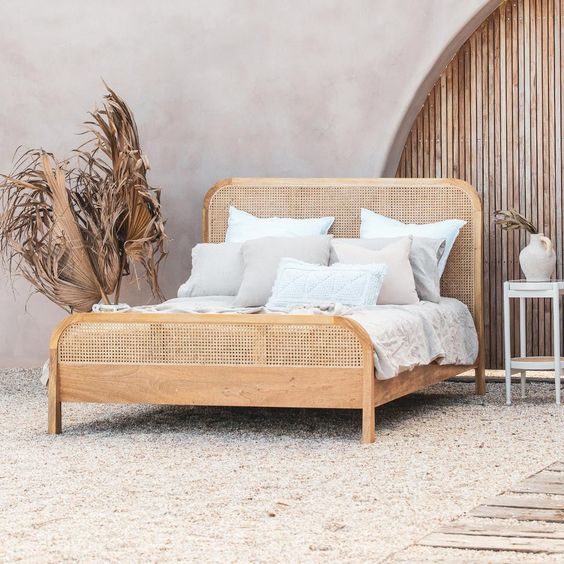 Rattan bedframe with plants on the side