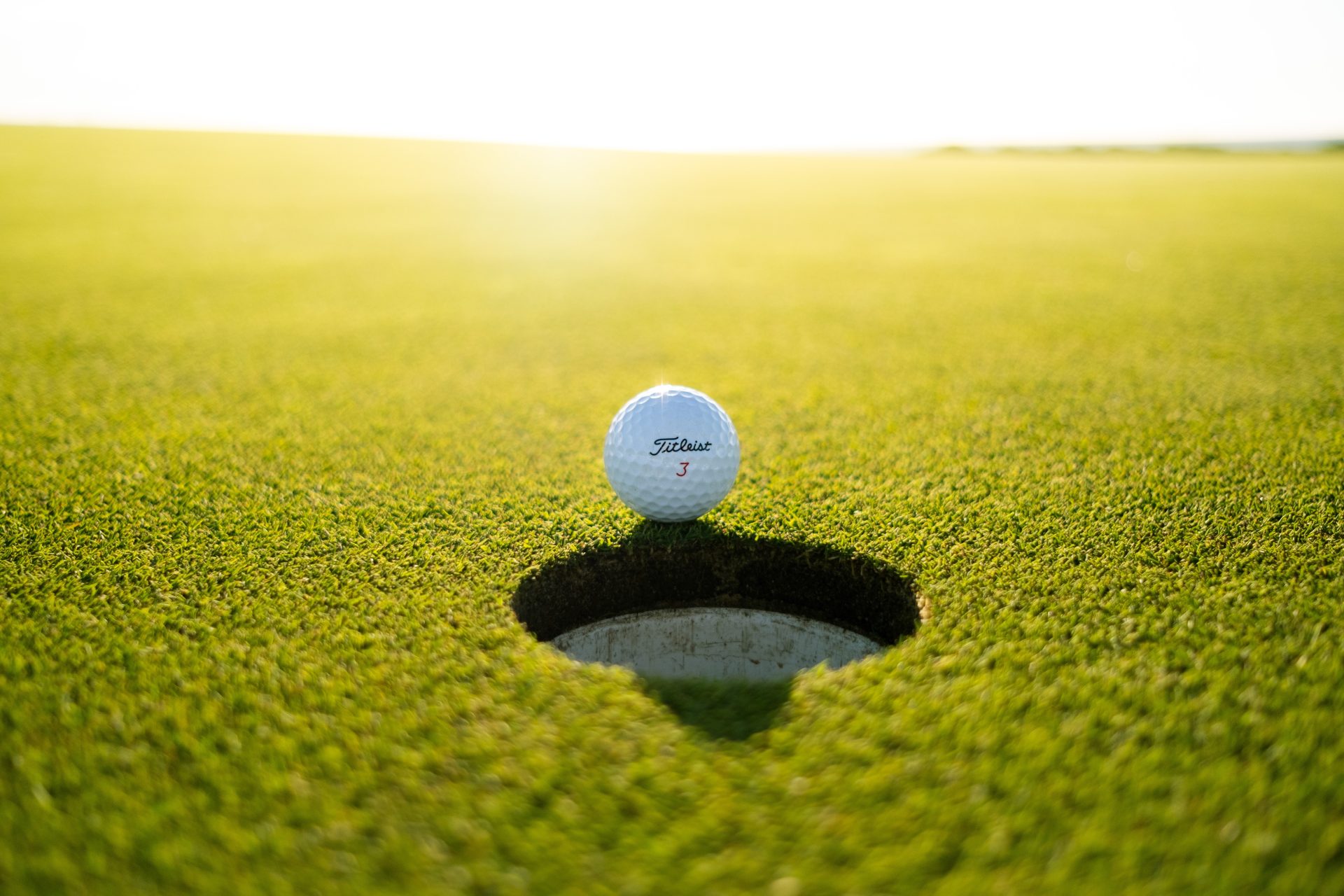 Golf ball on green grass during daytime