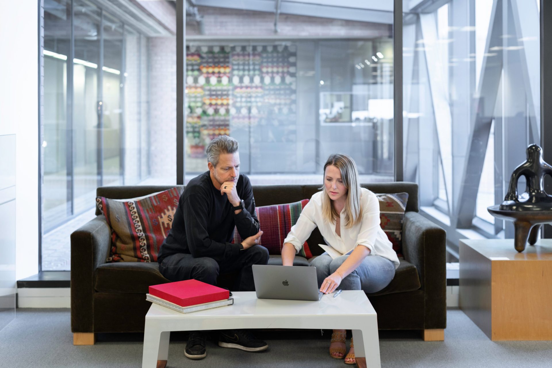 A real estate agent presenting to her old client using macbook